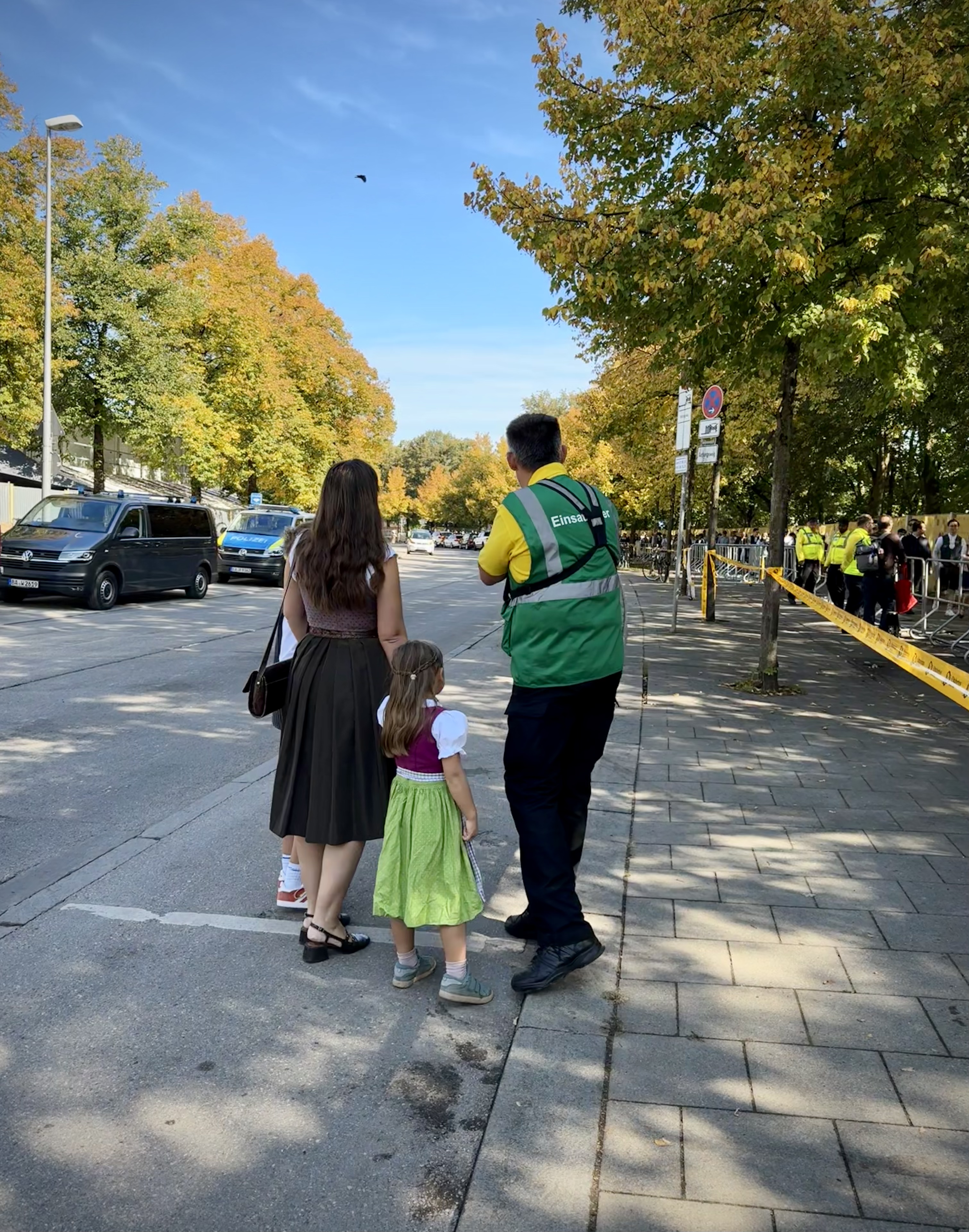 Security guard giving directions to mother and daughter at Oktoberfest.